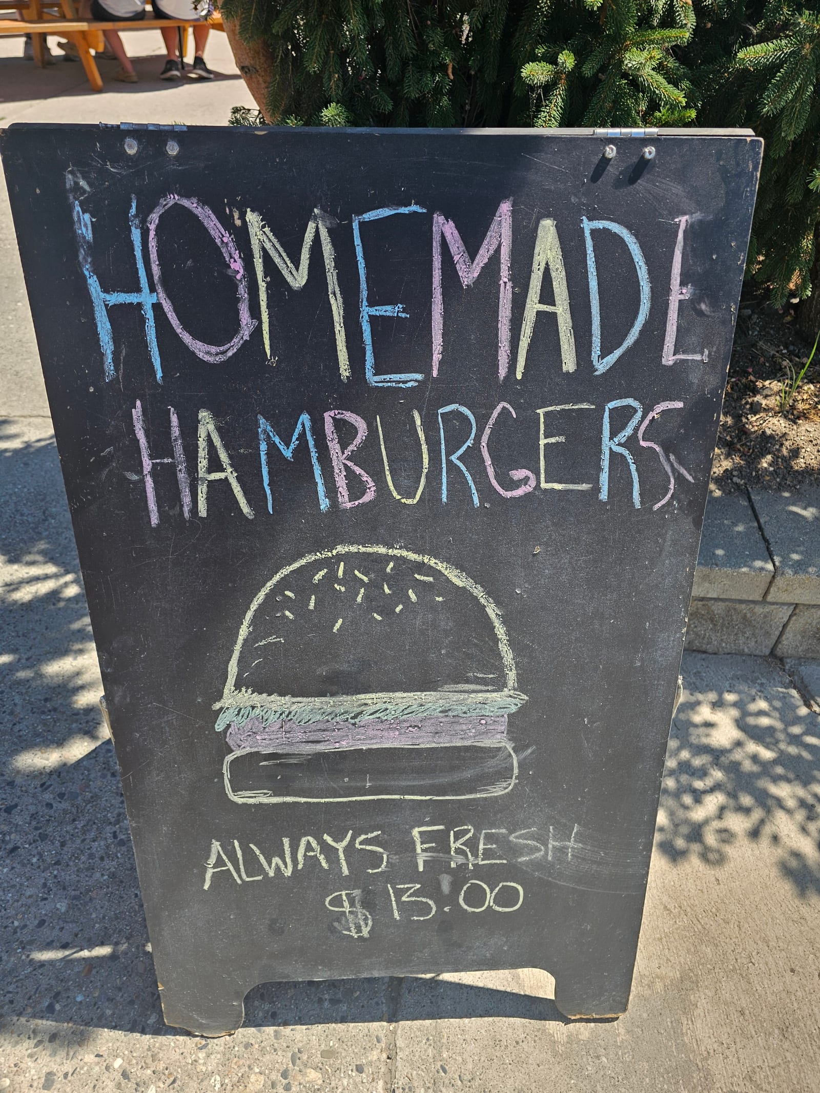 Hand-chalked sandwich board at Lu Lou's in Oyama reading Homemade Hamburgers, Always Fresh, with a burger drawn in chalk